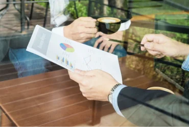 two-businessman-discussing-their-chart-coffee-shop